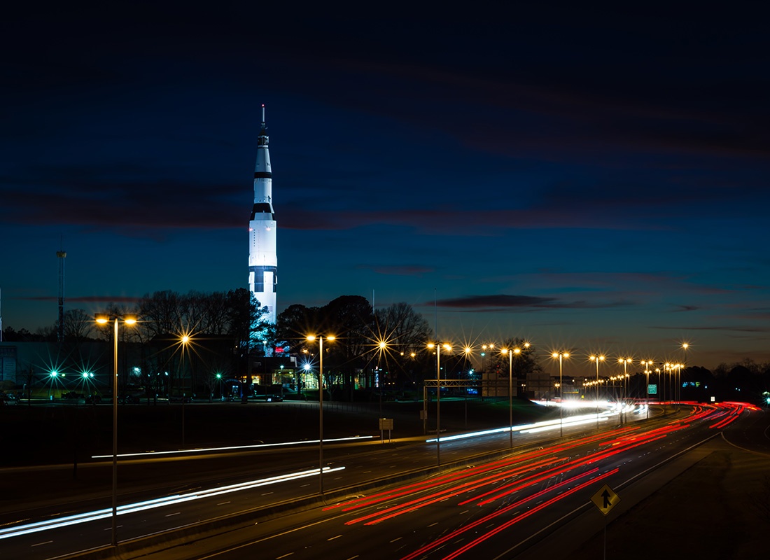 Contact - View of the Alabama Space Center in Huntsville Alabama Next to an Empty Lit Up Highway at Night
