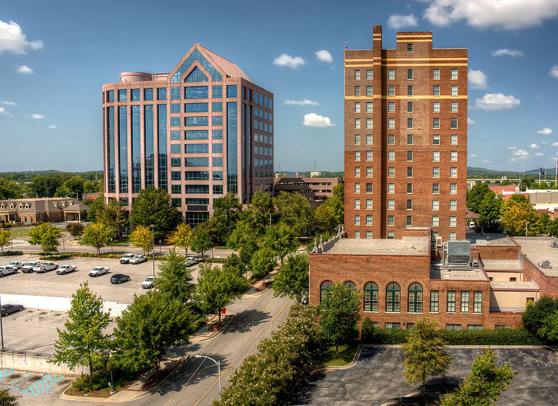 Insurance by Industry - View of a Modern and Traditional Brick Building in Downtown Huntsville Alabama Surrounded by Green Trees on a Sunny Day